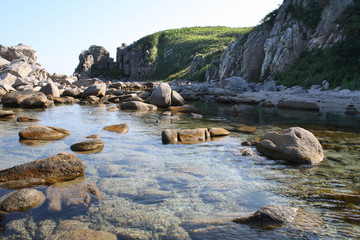 Beautiful landscape of a blue evening sea, horizon and rocks