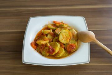 olive oil zucchini food in the white plate on the wooden table for restaurant or kitchen concept.