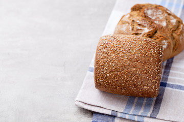 Gold rustic crusty loaves of bread and buns on wooden background. Still life captured from above top view, flat lay.