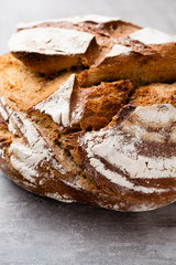Gold rustic crusty loaves of bread and buns on wooden background. Still life captured from above top view, flat lay.
