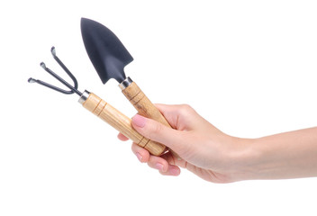 gardening tools rake shovel in hand on white background isolation