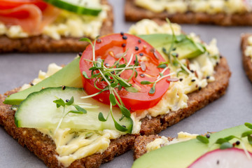 Fototapeta na wymiar Sandwiches with cream cheese, vegetables and salami.