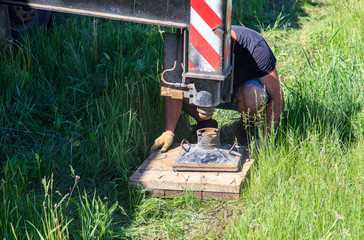 Worker installs crane paws at a house construction