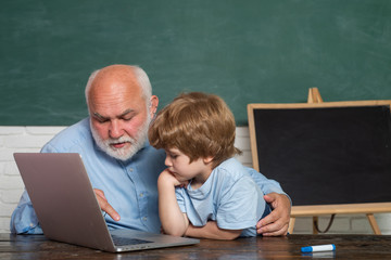 Teacher and child. His enjoys talking to grandfather. Daddy and son together. Young serious male Pupil studying in school. Back to school. Old teacher.