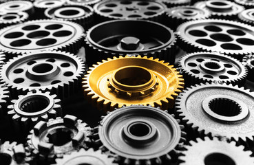 Keyman,key success or leadership concepts with metal gold cog outstanding in another cogs.Business...