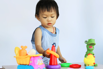 Happy Asian baby child girl playing and learning with many toys. Development of baby aged of one year old concept.