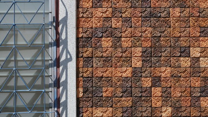 Sunlight and shadow on surface of the old white louver window with square pattern of sandstone brick wall background in vintage style