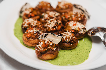 vegan gluten-free champignon with fiery vegetable and nuts, spinach emulsion