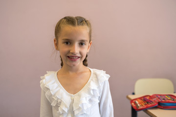 Pretty elementary school girl posing at camera