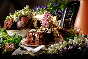 Chocolate muffins with chocolate syrup on dark background, selective focus