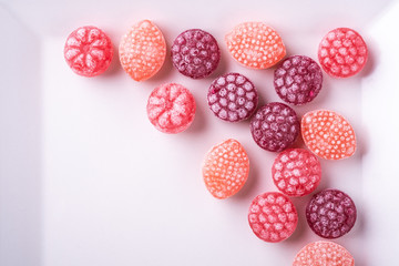 Candy canes sweets in form of juicy berries on white background isolated top view