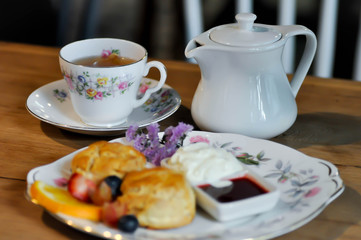 tea , teapot and scone with fruit
