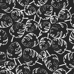 Seamless floral pattern. Palm leaves. The contours of the leaves. Chalk on black board.