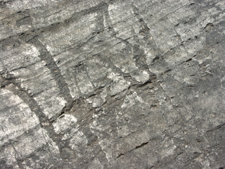 Typical detail of an ancient wall of an Italian house in Rimini, on the Adriatic coast, made of hand-carved stones.