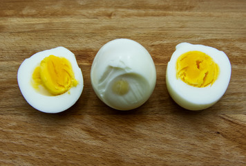  Boiled egg with a cut boiled egg on wooden table
