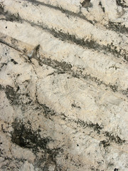Typical detail of an ancient wall of an Italian house in Rimini, on the Adriatic coast, made of hand-carved stones.