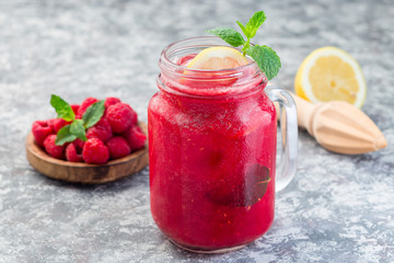Refreshing raspberry, lemon and mint lemonade with sparkling water in  jar, horizontal