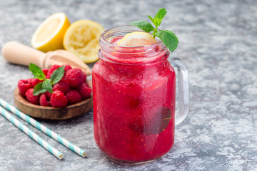 Fototapeta na wymiar Refreshing raspberry, lemon and mint lemonade with sparkling water in a jar, horizontal, copy space