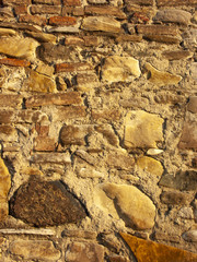 Typical detail of an ancient Italian house wall, made of hand-carved river stones.