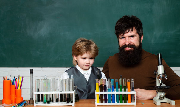 Happy little scientist making experiment with test tube. Young boy doing his school homework with his father. Home schooling. Chemistry the Science Classroom