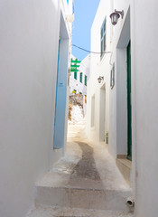  Narrow Street with white houses and blue doors and windows in the Greek white and blue style of the Greek city