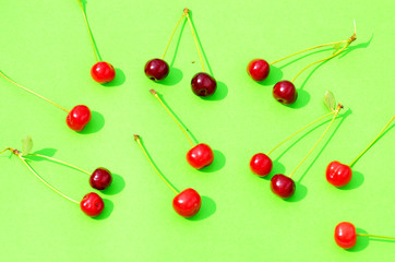 Red cherry isolated on green background, fruit pattern,photo