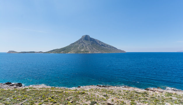 bright blue sea green hills and hills Island Telendos on the horizon in Greece Island Kalymnos