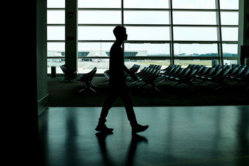 Fototapeta na wymiar silhouette shadow in airport man woman walking shadow