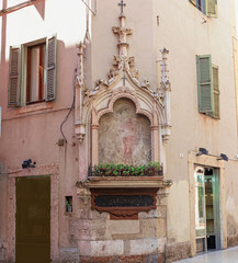 Fototapeta na wymiar ancient votive shrine in a crossroad in the pedestrian zone. Verona, Italy