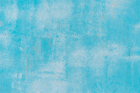 Blue and white old cracked paint pattern on wall. Peeling paint background. Pattern of rustic blue grunge material. Damaged paint. Blue texture of shabby paint and plaster cracks