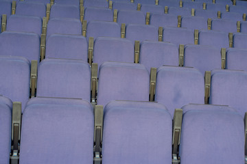 Purple empty seats in the stand in the sports arena.