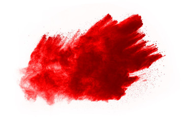 Freeze motion of red powder exploding, isolated on white background. Abstract design of red dust...