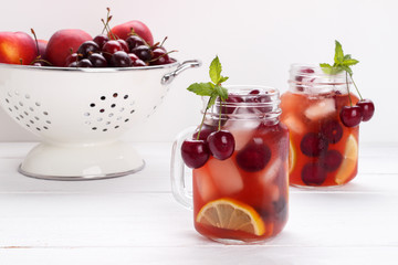 Infused flavored water with cherry, lemon and mint