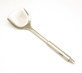 Stainless steel pan shovel used in cooking on a white background