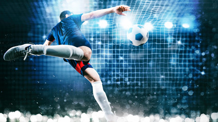 Football scene at night match with player kicking the ball with power - obrazy, fototapety, plakaty