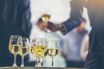 Group of elegant people holding glasses of champagne at luxury party. people toasting and cheering with drinks at social events. christmas celebration