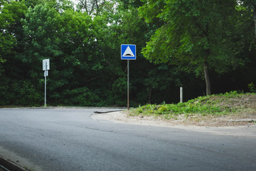 asphalt road with a blue crosswalk.