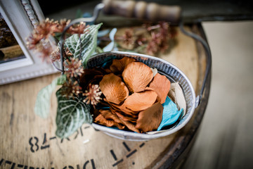 Closeup of flower petals in a basket with rustic theme and fall colors.