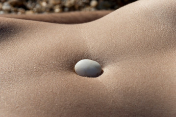 Milos Island, Cyclades islands / Greece 2018: A belly and a pebble at the beautiful island of Milos