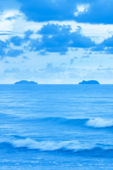 Naklejka na ściany i meble A tranquil blue sea after stormy days.