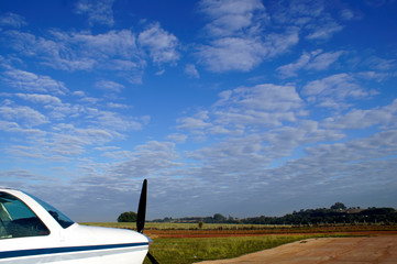 Small airplane in the Airclub with a beautiful sky in the background.