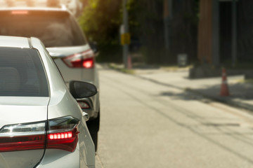 Luxury of silver car stop on the asphalt junction by traffic light control. Traveling in the provinces during the bright period. Open light break. 