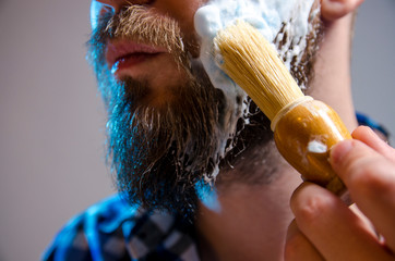 Closeup man putting shaving cream with brush  - Powered by Adobe
