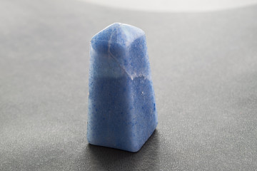 Blue quartz stone in the form of an obelisk close-up