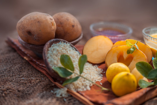 Face mask for the treatment of pigmentation on jute bags surface consisting of potato,lemon juice,honey and rice flour in a glass bowl.Entire constituents on the surface.Horizontal shot.