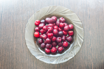 Ripe cherry berries in a plate for healthy food and eating close-up