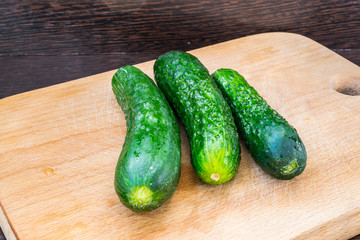 Three cucumbers on a cutting board for healthy eating and food