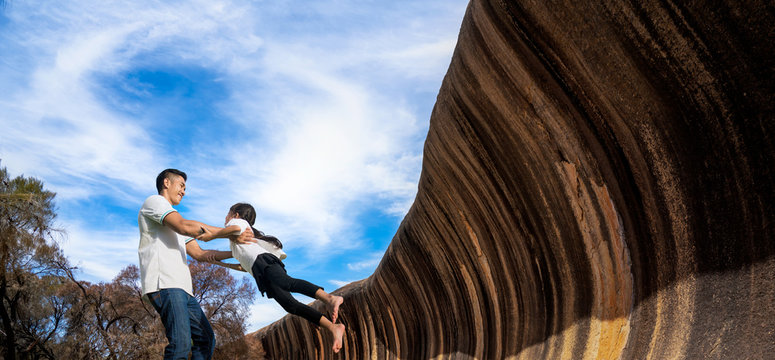 Father And He Baby Play And Relax Togather With Wave Rock Background