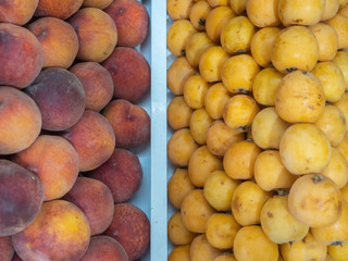 set of various types of peaches and fruits on fruit rack