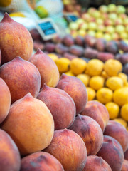 set of various types of peaches and fruits on fruit rack